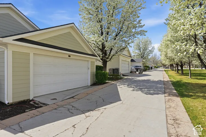 Horizontal lap siding exterior with attached garage and concrete driveway