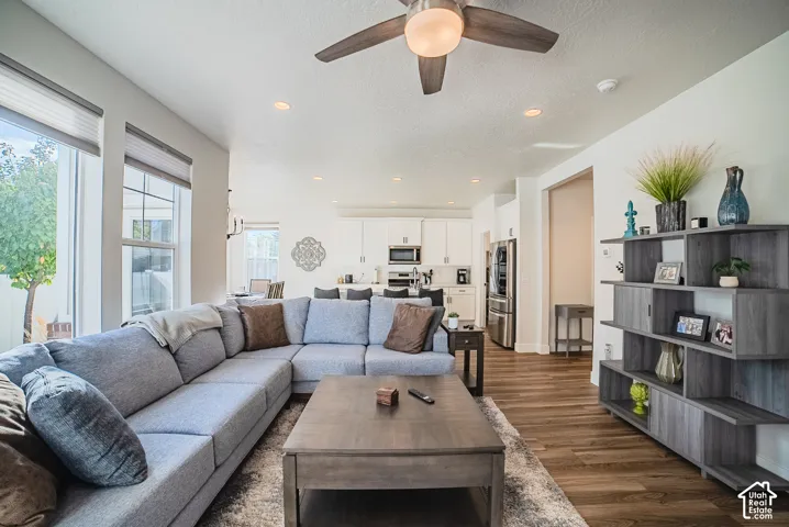 Open-concept interior featuring wood-finish flooring, recessed lighting, and a ceiling fan with integrated lighting