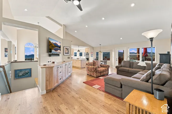 Vaulted ceilings, wood-finish flooring, custom built-in cabinetry, recessed lighting, and expansive windows showcasing mountain scenery