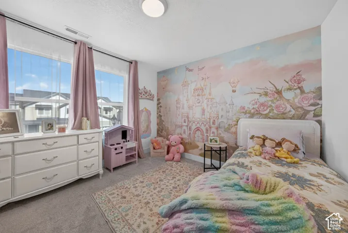Neutral wall-to-wall carpeting, expansive windows, and a flush-mount ceiling light fixture