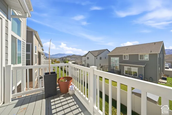 Elevated deck with white vinyl railing, grey composite decking, and mountain backdrop