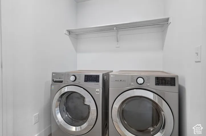 Utility space featuring white walls and a built-in white shelf with a hanging rod