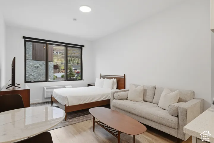 Light-filled room featuring large, multi-pane windows with mountain scenery, recessed ceiling lighting, and wood-finish flooring