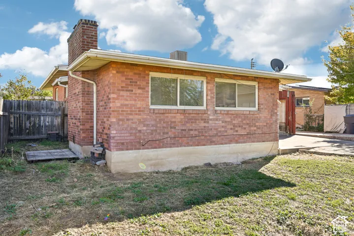 Brick exterior with a masonry chimney and concrete foundation