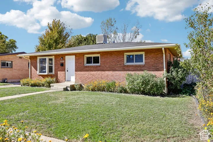 Single-story brick exterior featuring a bay window, concrete front entry steps, and a low-pitch roof