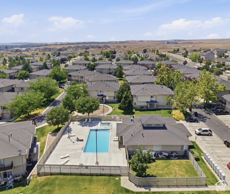 Community grounds featuring an outdoor swimming pool, in-ground spa, fenced perimeter, and landscaped green space
