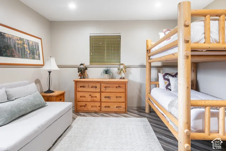 Neutral interior featuring wood-finish flooring, recessed lighting, and a chair rail