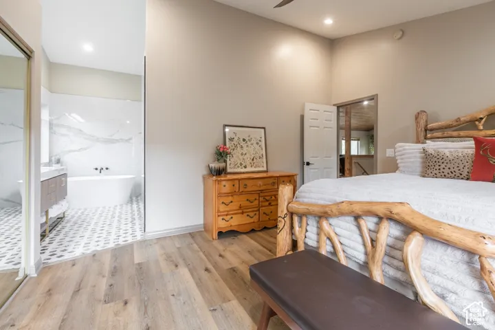 Room featuring wood-finish flooring, recessed lighting, and high ceilings