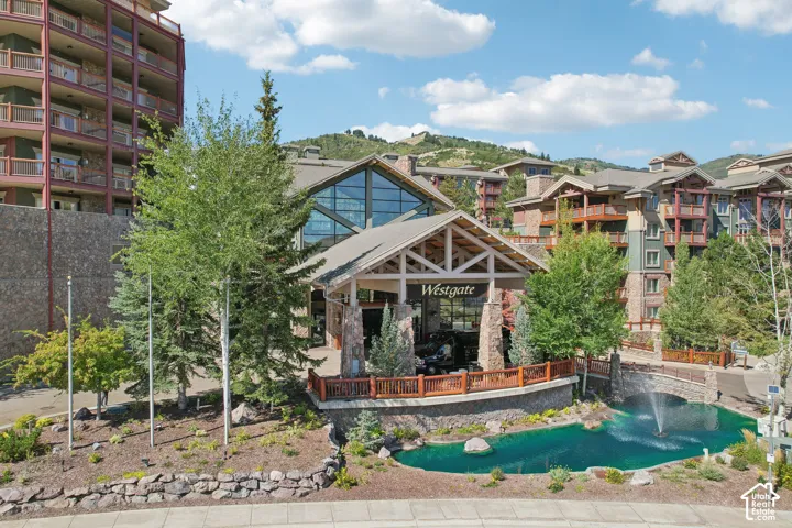 Multi-story building complex featuring stone and timber construction, a covered porte-coch
