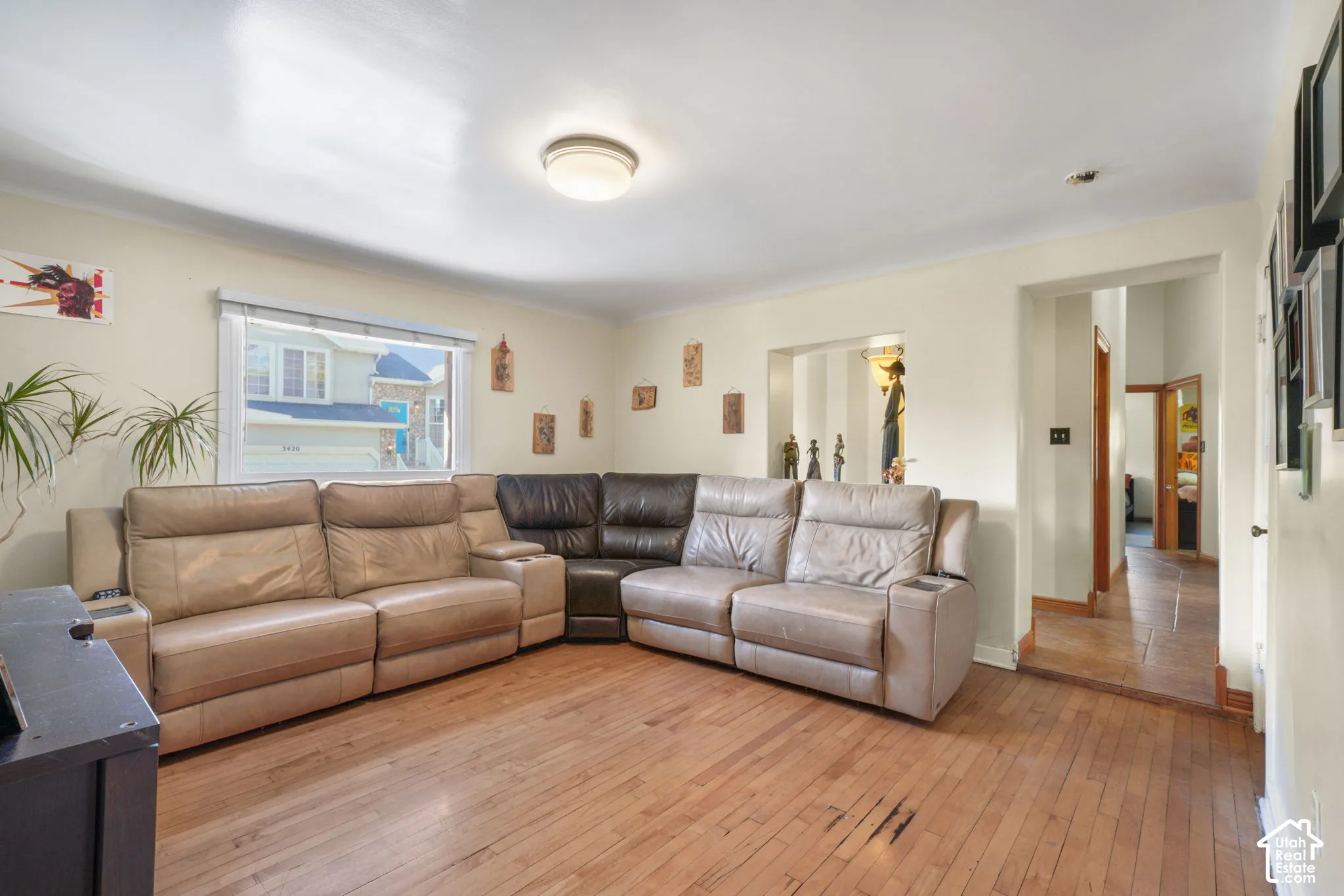 Living space featuring wood-finish flooring, a neutral color palette, and a recessed wall opening