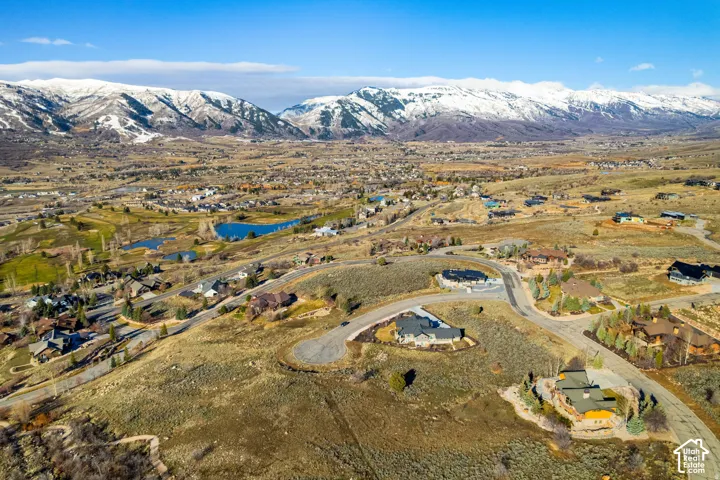 Aerial overview of property's location with nearby suburban area and a water and mountain view