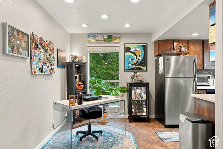 Recessed ceiling lighting, stainless steel refrigerator, and tiled flooring