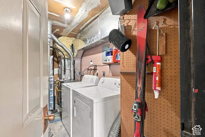 Laundry area featuring built-in metal ductwork, dedicated HVAC system, and wall-mounted pegboard storage