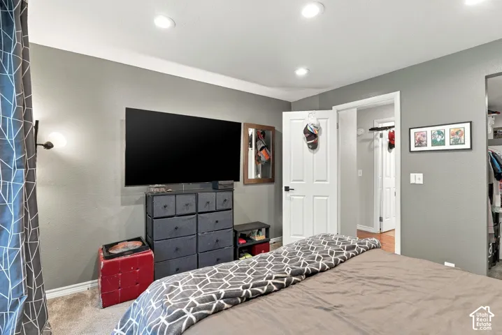Neutral-toned interior featuring recessed lighting and a six-panel door with matte black hardware