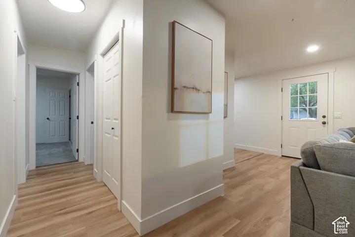 Neutral-toned interior featuring wood-finish flooring, white panel doors, and a glass-paneled exterior door