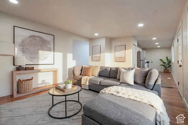Living area featuring recessed lighting, neutral wall finishes, and wood-finish flooring