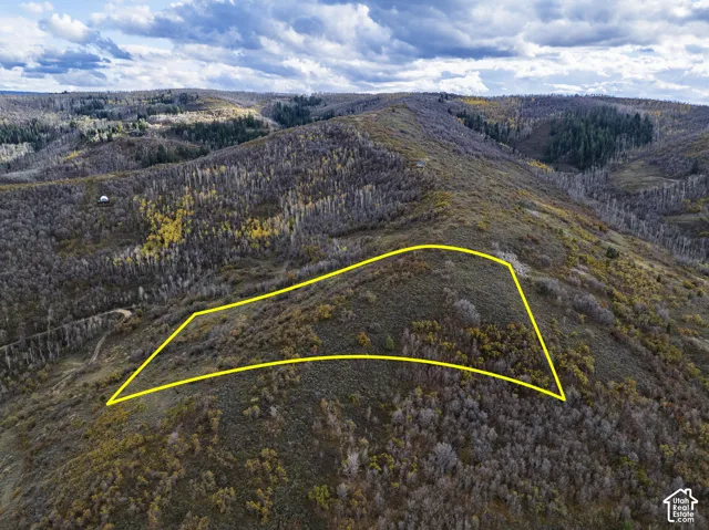Expansive hillside parcel featuring rolling topography, native vegetation, and panoramic mountain terrain