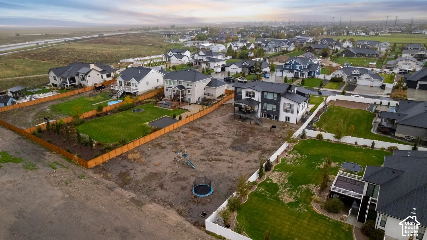 Aerial perspective featuring residential lots with fenced perimeters and open space potential
