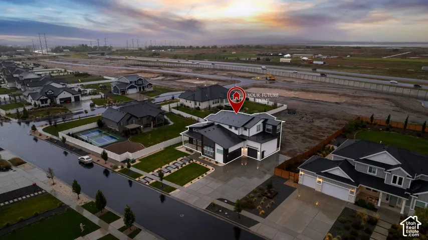 Two-story residence featuring a multi-pitched roofline, light-colored exterior siding with dark trim accents, an attached multi-car garage, concrete driveway, and a paved walkway
