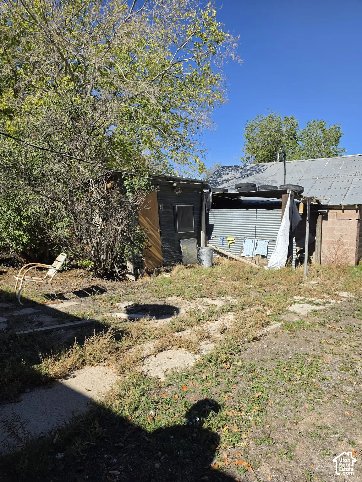 Exterior structures featuring corrugated metal siding, concrete block masonry, and pitched metal roofing