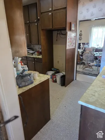 Kitchen area featuring wood cabinetry, laminate countertops, and hard-surface flooring