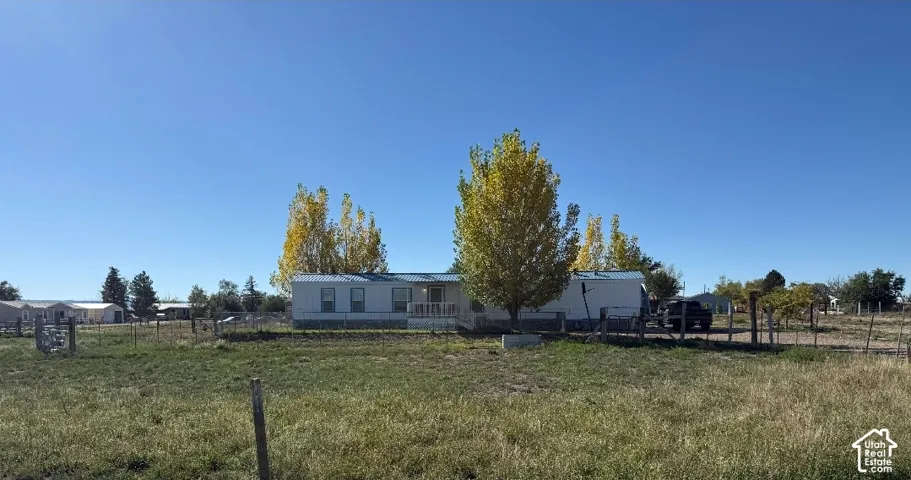 Single-level residence featuring a metal roof, exterior siding, and a fenced perimeter