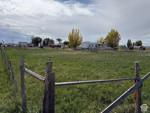 Expansive acreage featuring mature trees, open pasture, and split-rail perimeter fencing
