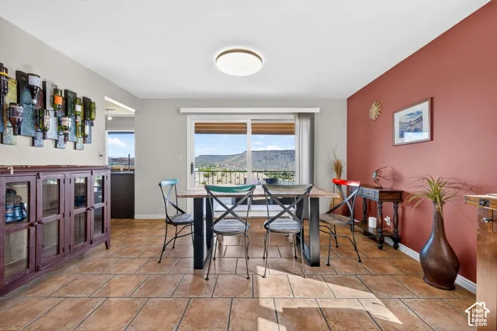 Ceramic tile flooring, sliding glass door, built-in cabinetry, flush-mount ceiling lighting, and mountain scenery