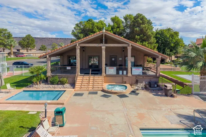 Community facility featuring a covered porch, swimming pool, in-ground spa, and concrete patio area