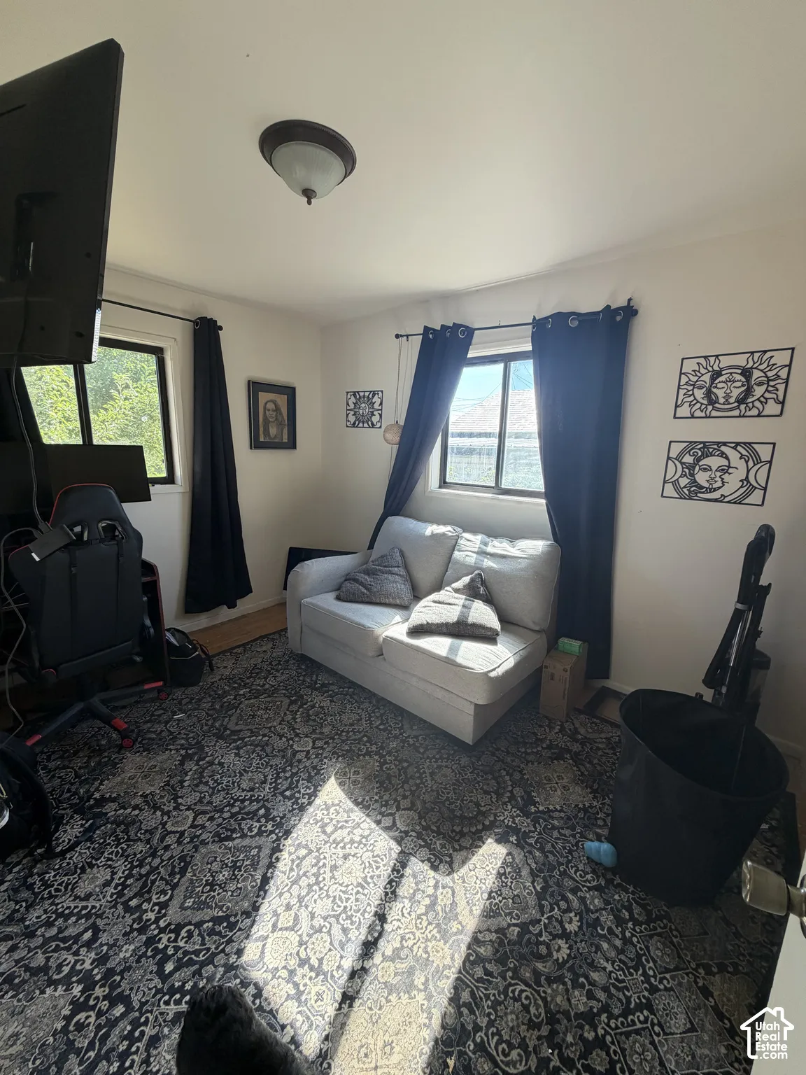Interior room featuring two windows, neutral wall coloring, and a dome-style flush-mount ceiling light fixture