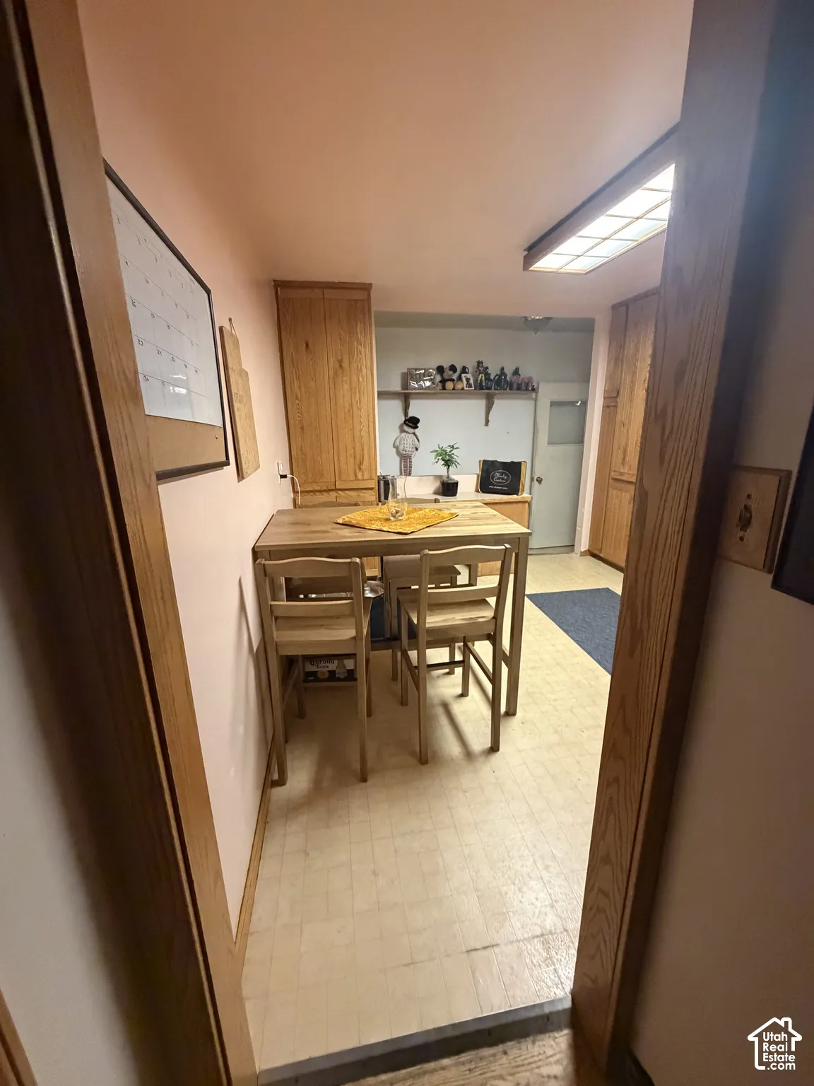 Full-height wood cabinetry with built-in storage, tile flooring, and integrated ceiling lighting