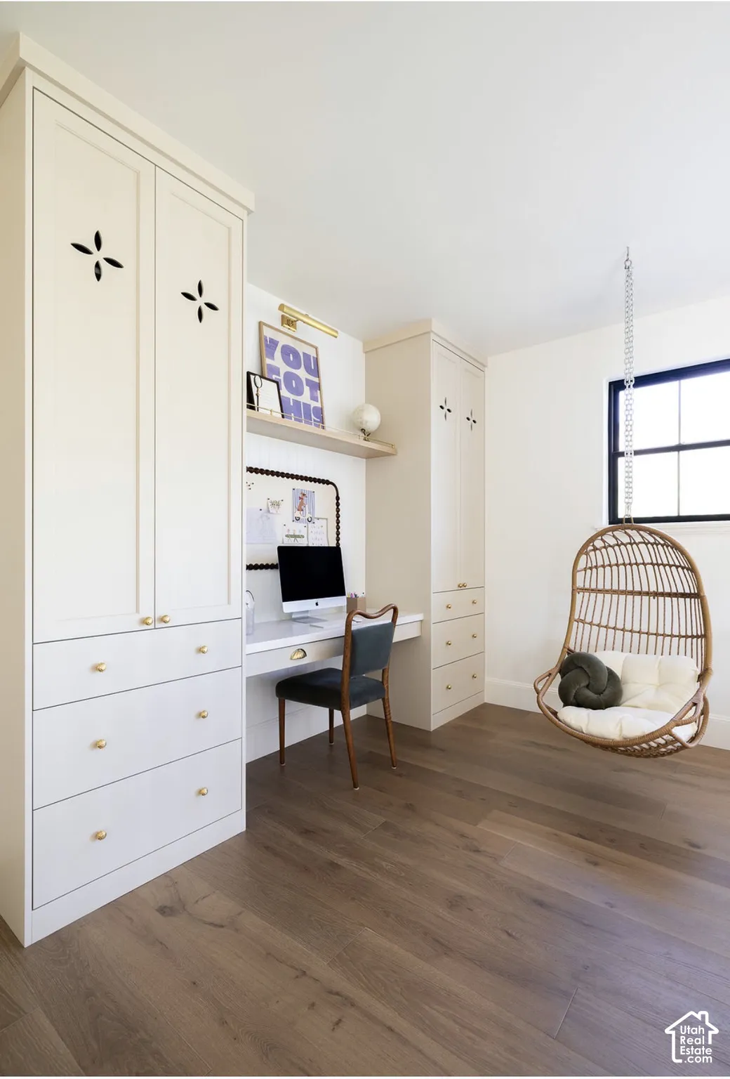 Custom built-in cabinetry featuring shaker-style doors, brass hardware, and integrated desk workspace with floating shelving