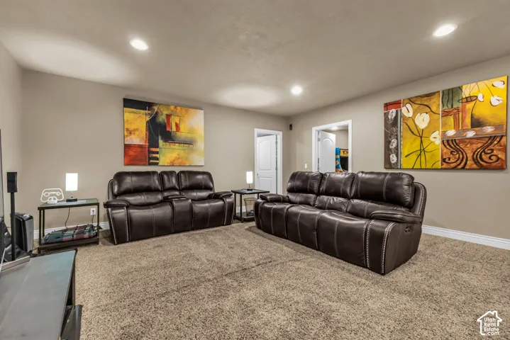 Neutral-toned interior space featuring recessed ceiling lighting, wall-to-wall carpeting, and solid-core interior doors