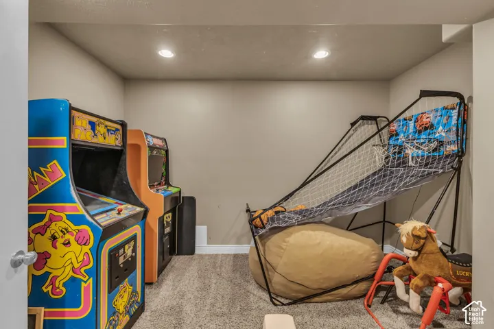 Enclosed room featuring neutral-toned walls, recessed ceiling lighting, and carpeted flooring