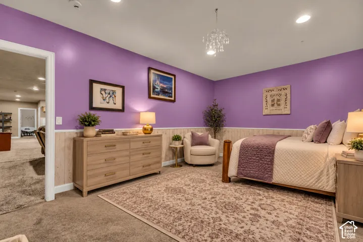 Room featuring wainscoting, recessed lighting, and a multi-tiered crystal-style chandelier
