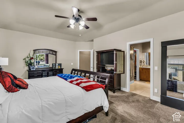 Neutral wall color, tray ceiling, and a ceiling fan with integrated light fixture
