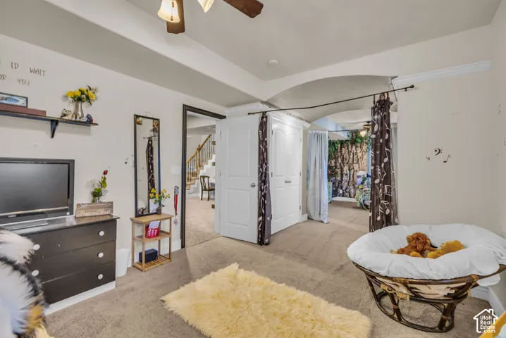 Tray ceiling, recessed lighting, neutral wall palette, double-door reach-in closet, and arched doorway entry