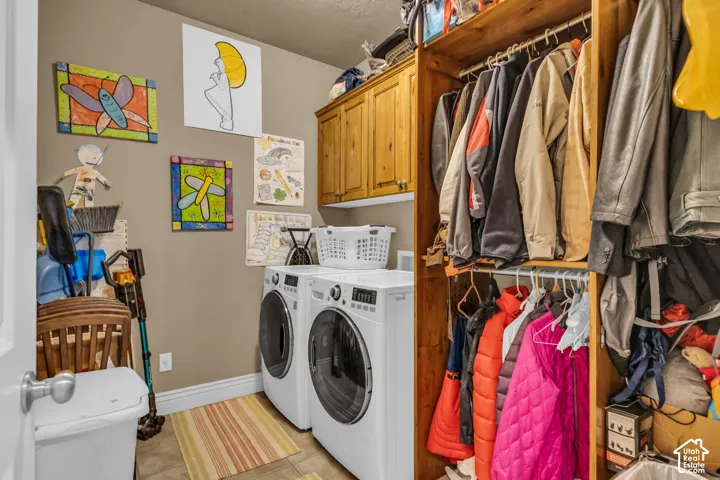 Utility room featuring natural wood-finish overhead cabinetry, open shelving, and neutral tile flooring
