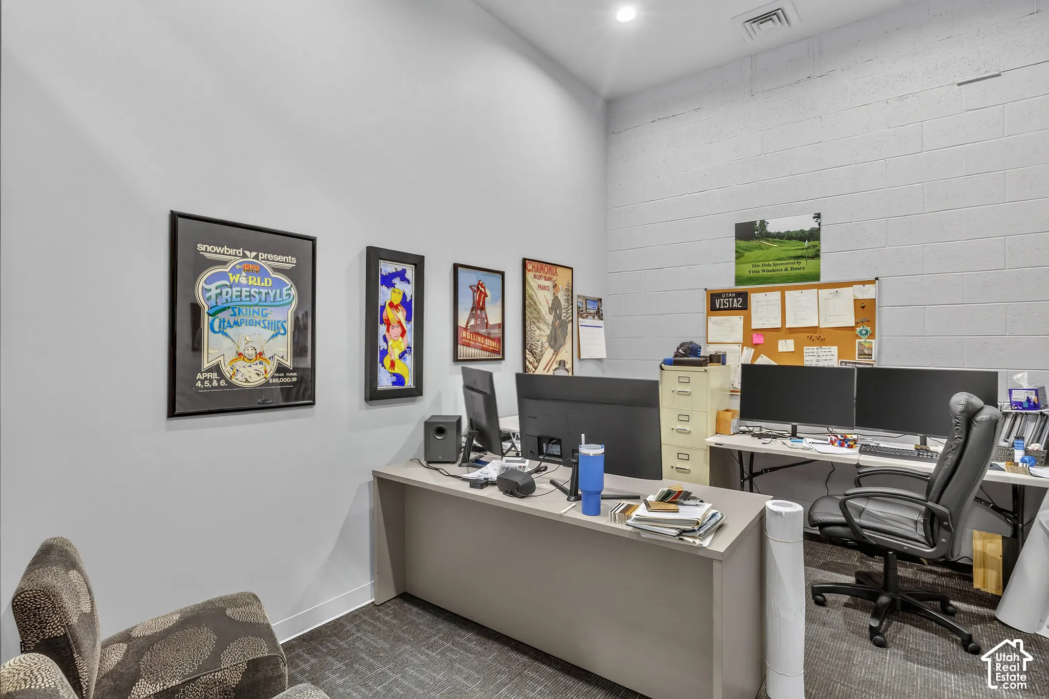 Interior space featuring high ceilings, painted masonry walls, and neutral carpeting