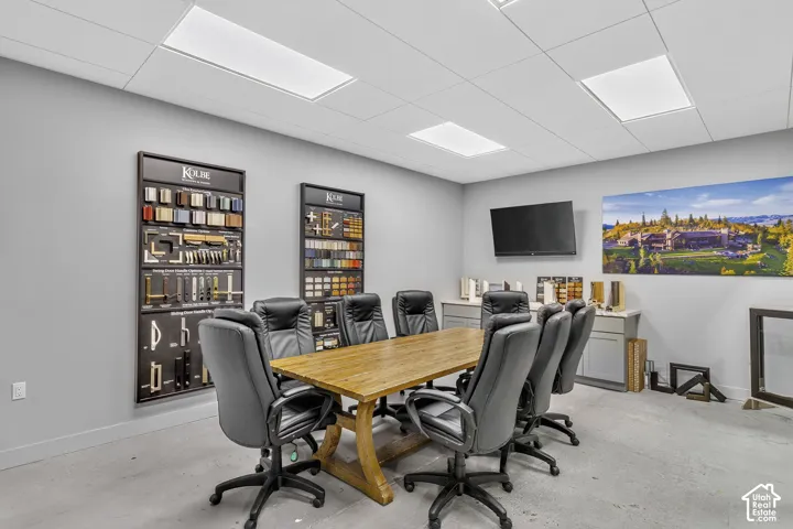 Drop-ceiling panels with recessed LED lighting, integrated cabinetry, and neutral-tone wall surfacing