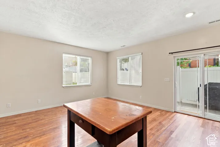 Interior space featuring wood-finish flooring, recessed lighting, double-pane windows, and a sliding glass door