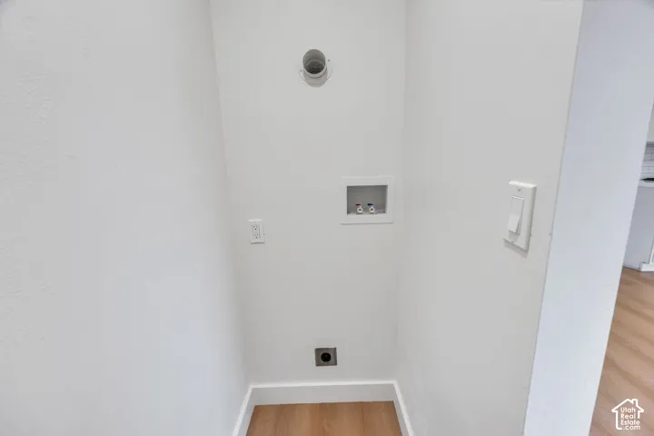 Dedicated utility area featuring washer and dryer hookups, recessed water supply box, and dedicated electrical outlet