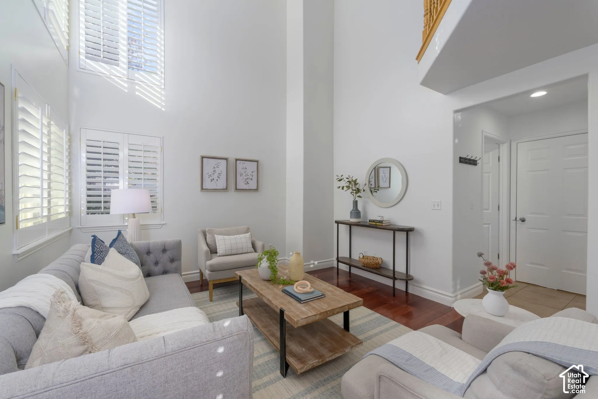 Double-height ceilings, hardwood flooring, and multi-tier plantation shutters