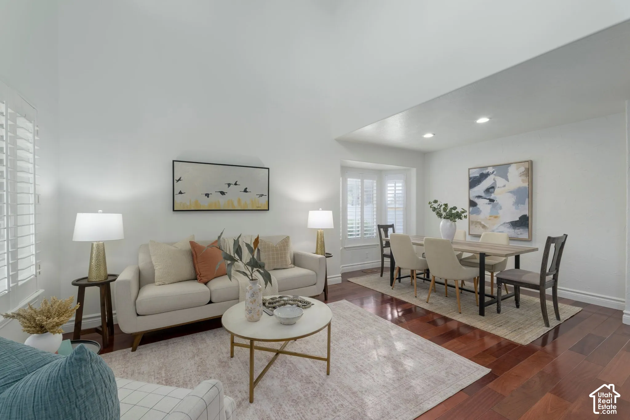 High ceilings, wood-finish flooring, bay window with plantation shutters, and recessed lighting