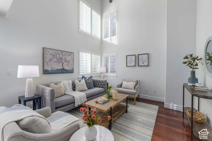 Double-height ceilings, expansive stacked windows, interior plantation shutters, and polished wood-finish flooring