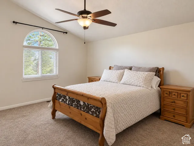 Primary bedroom featuring vaulted ceilings