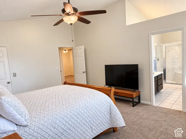 Primary bedroom featuring vaulted ceilings