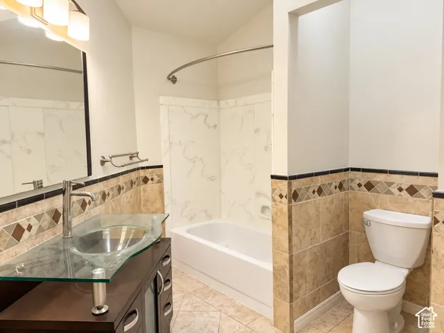 Main bathroom featuring custom vanity and tile