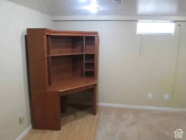 Room featuring neutral wall paint, carpeted flooring, and a horizontal window with blinds