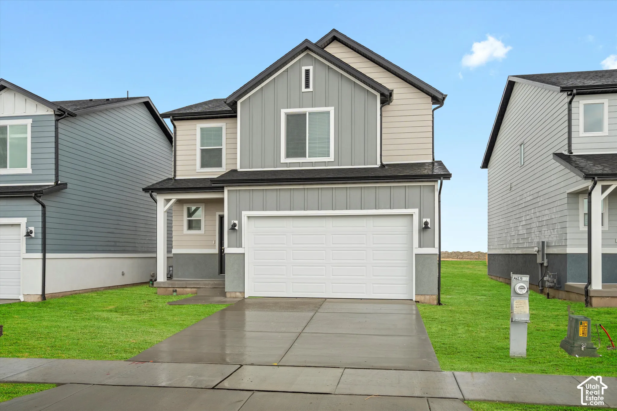 **DISCLAIMER** Elevation and exterior color may vary. Exterior featuring mixed board-and-batten and horizontal siding, two-car garage, concrete driveway, and covered front entry